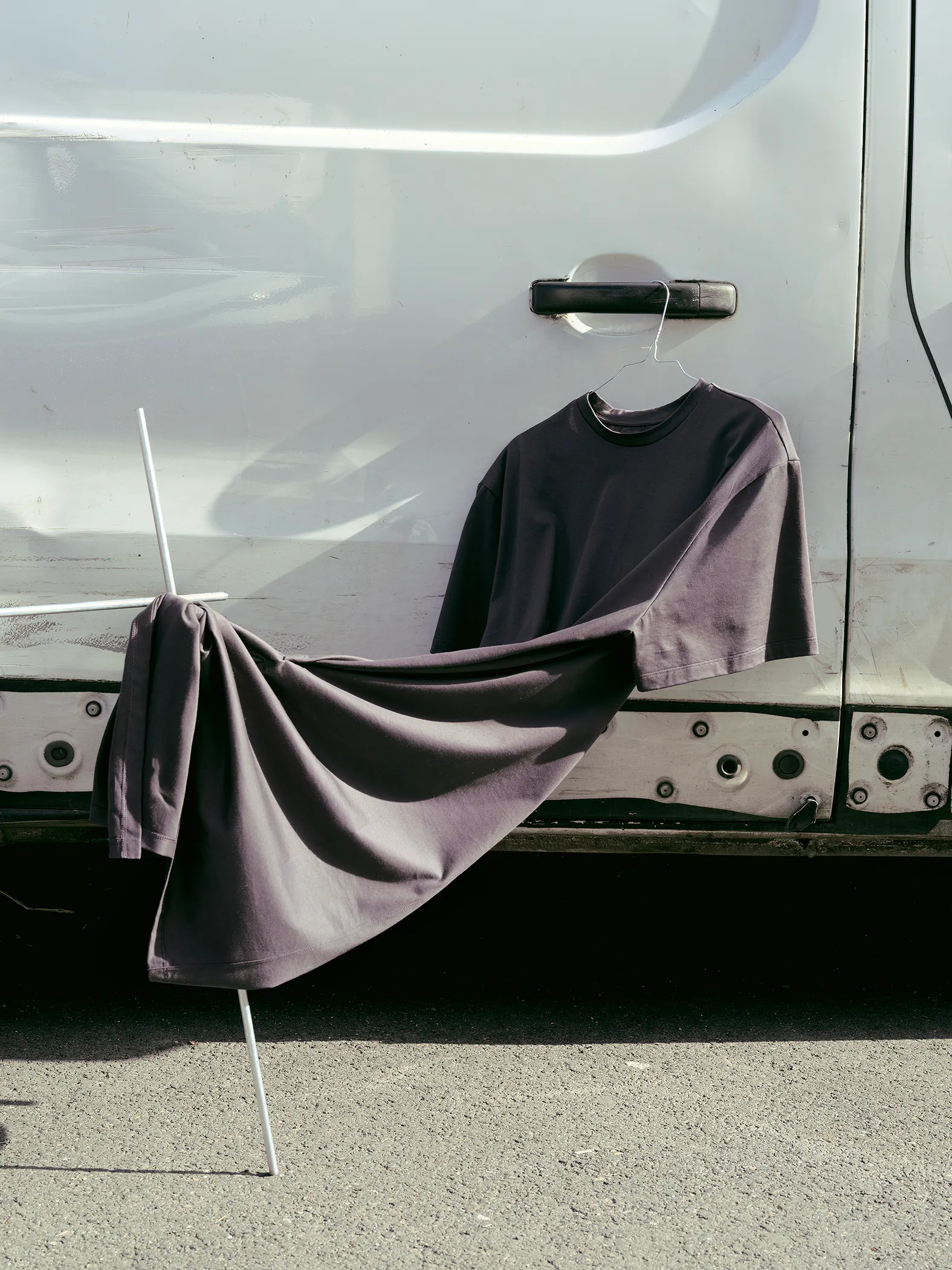 Black Drop 3 garments displayed against a truck